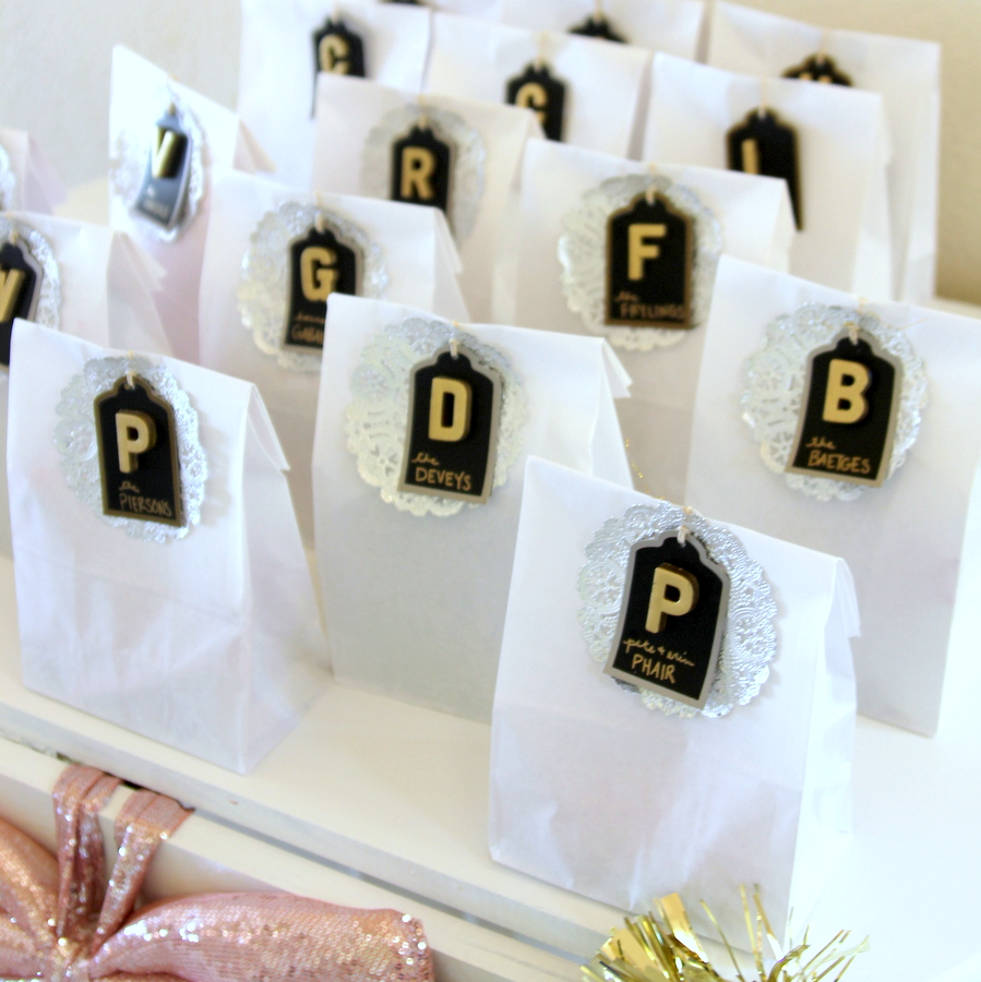 glitter party favor bags- white paper lunch sacks filled with sparkle-y gifts and treats